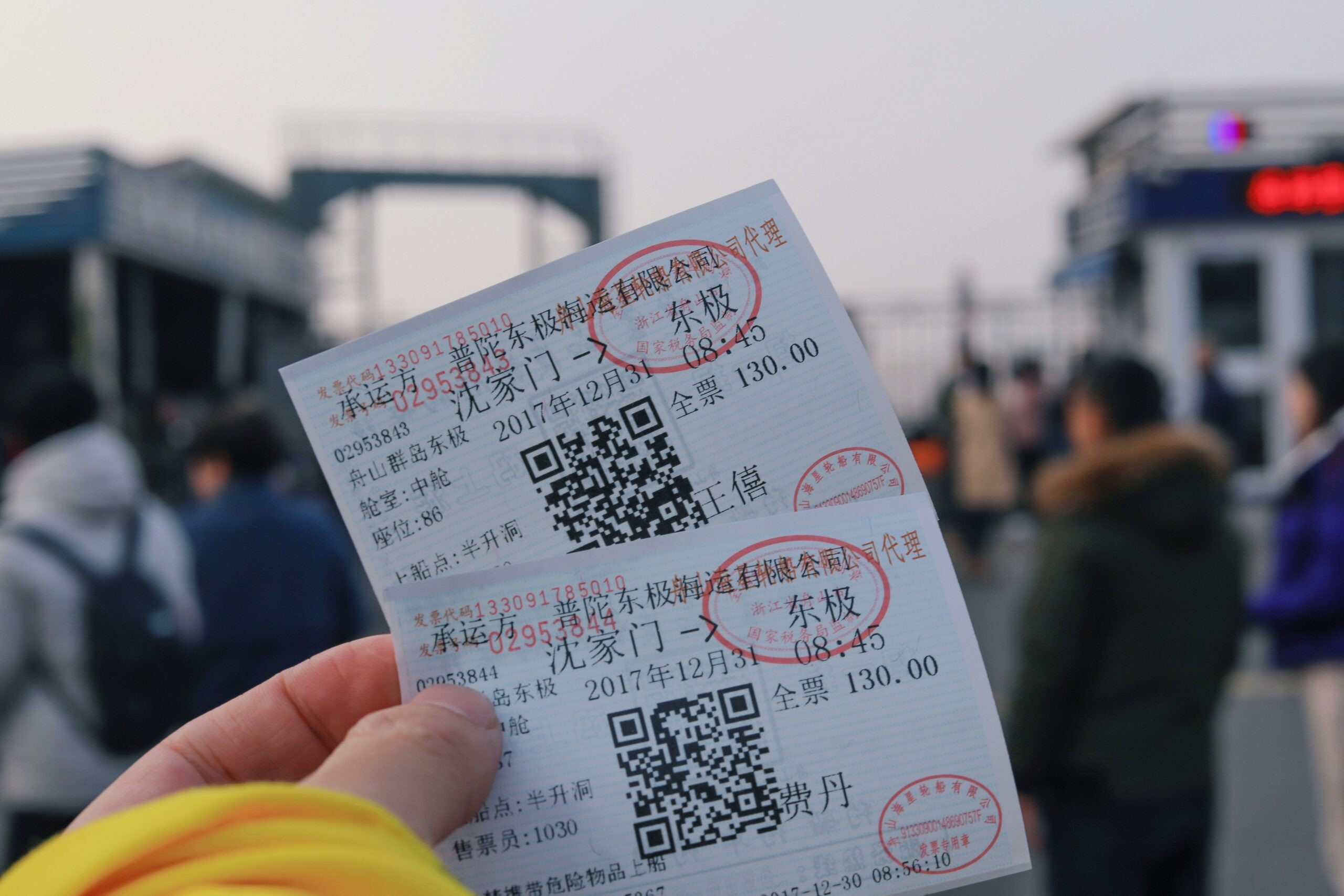 person holding two white tickets